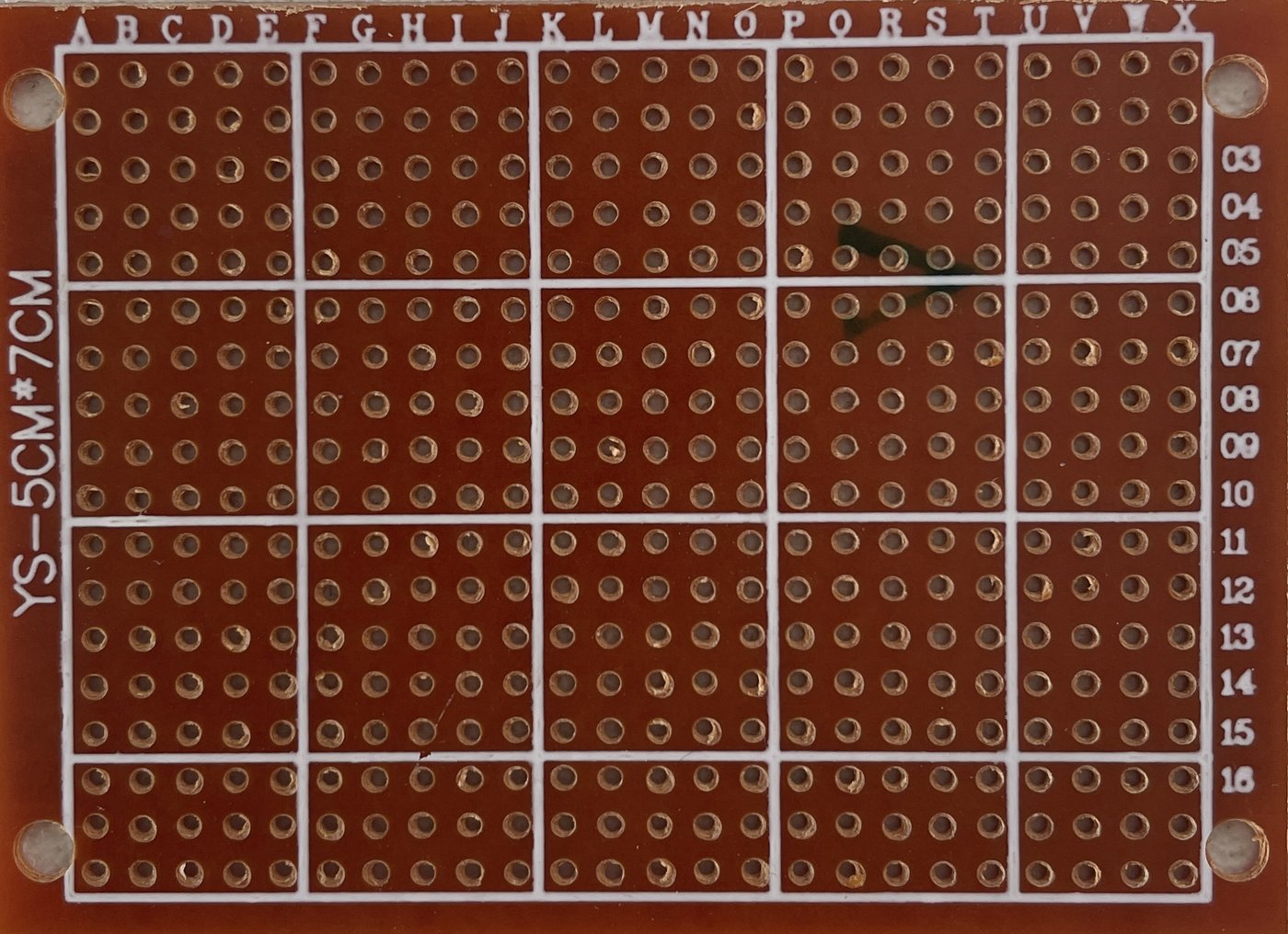 Photograph of the 50 by 70 millimetre prototype panel from the component side, showing the 24 by 18 hole grid on a 2.54 millimetre pitch.